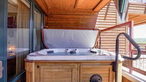 View of patio with a hot tub