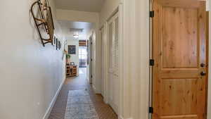Corridor featuring carpet and baseboards