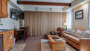 Living room featuring beam ceiling