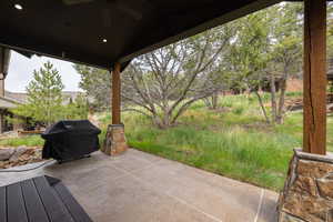 View of patio / terrace with a ceiling fan and a grill