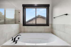 Full bathroom featuring a whirlpool tub