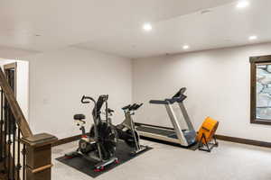 Exercise area with carpet flooring and recessed lighting