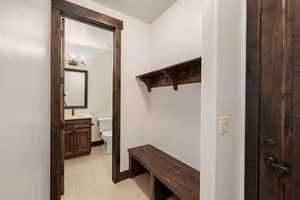 Mudroom with light floors and baseboards