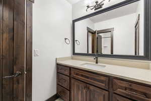 Bathroom featuring vanity and baseboards