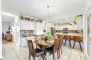 Dining space with light tile patterned floors
