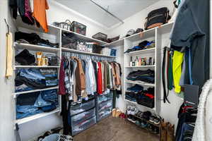 Walk in closet with dark carpet