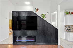 Detailed view of decorative backsplash and wood finished floors