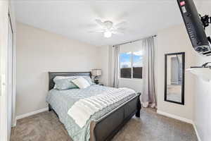 Bedroom featuring carpet and ceiling fan