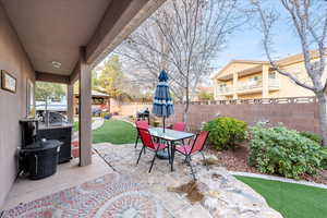 Fenced backyard with a gazebo, a patio, outdoor dining space, and a grill