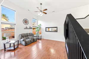 Living room with light wood-style flooring and a ceiling fan