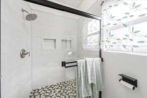 Full bath featuring a shower stall