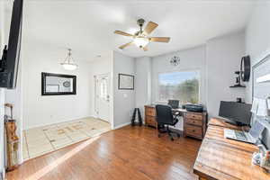 Office area featuring light wood-type flooring and ceiling fan