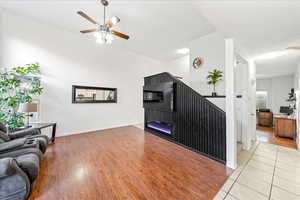 Living room featuring light wood-type flooring and a ceiling fan