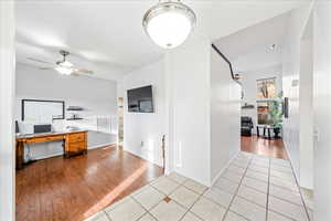Office area with light tile patterned floors and ceiling fan