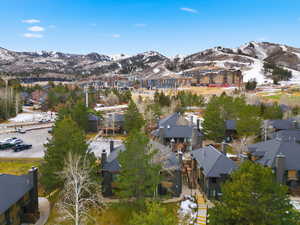 Aerial view of property's location featuring a mountainous background and nearby suburban area