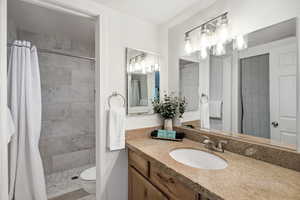Full bathroom with vanity and a stall shower