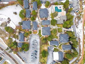 Aerial view of property and surrounding area featuring nearby suburban area