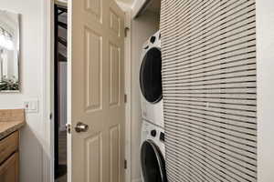 Washroom featuring stacked washer and clothes dryer
