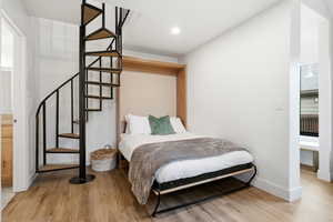 Bedroom featuring connected bathroom and light wood finished floors