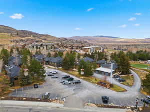 Aerial overview of property's location with a mountain backdrop and nearby suburban area