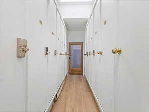 Corridor featuring light wood finished floors