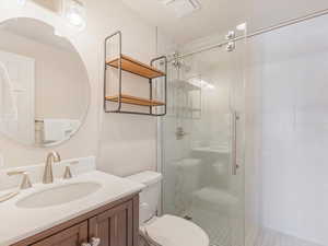 Bathroom featuring vanity and a shower stall