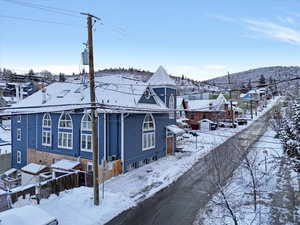 Snow covered property featuring a mountain view