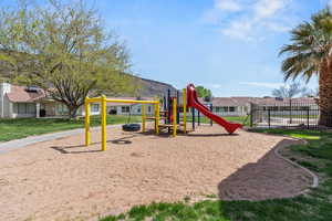 Community play area with a residential view and a yard