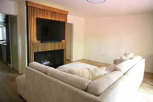 Living room with wood finished floors and a fireplace