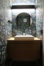 Bathroom featuring vanity and wallpapered walls