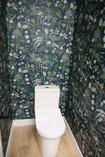 Bathroom with toilet and wood finished floors