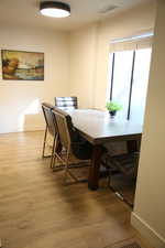 Dining space with baseboards and light wood-style flooring