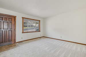 Entrance foyer featuring carpet and baseboards