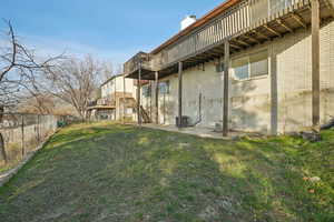 View of yard with a wooden deck and stairway