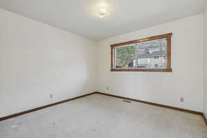 Spare room featuring carpet flooring and a textured ceiling