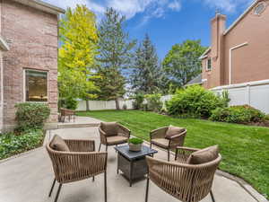 Fenced backyard with a patio area and an outdoor hangout area