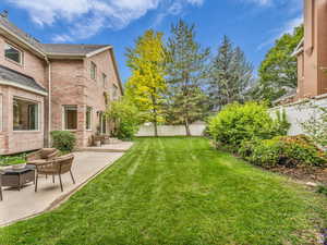 Fenced backyard featuring a patio and outdoor lounge area