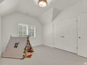 Playroom featuring carpet and lofted ceiling