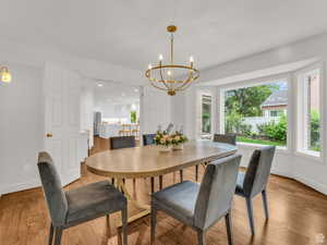 Dining area featuring wood finished floors, a chandelier, and recessed lighting