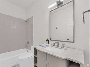 Full bath featuring shower / washtub combination and vanity