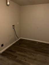 Laundry room with dark wood-style floors and electric dryer hookup