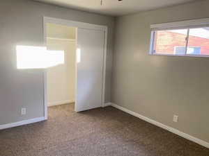 Unfurnished bedroom with carpet floors and a closet