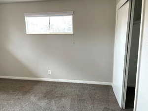 Unfurnished bedroom with carpet flooring and a closet