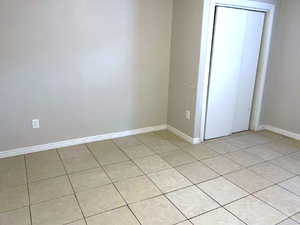 Spare room with light tile patterned flooring