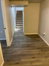 Hall with stairs and dark wood-style floors