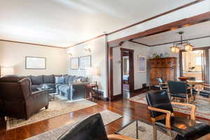 Living area featuring crown molding and hardwood / wood-style floors
