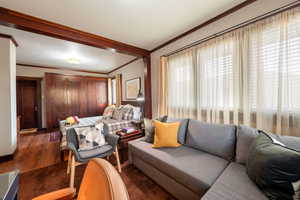 Living room featuring crown molding and wood finished floors