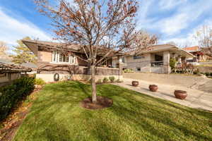 Back of house featuring brick siding, stucco siding, and a patio area