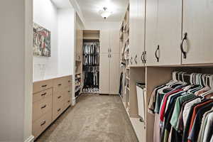 Primary closet with light colored carpet