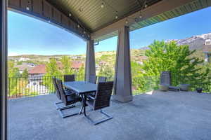 View of patio featuring a mountain view, outdoor dining space, and a residential view